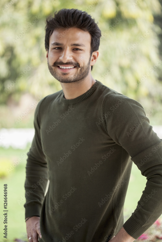 India, Smiley man standing with hands on hips India, Smiley man standing with hands on hips