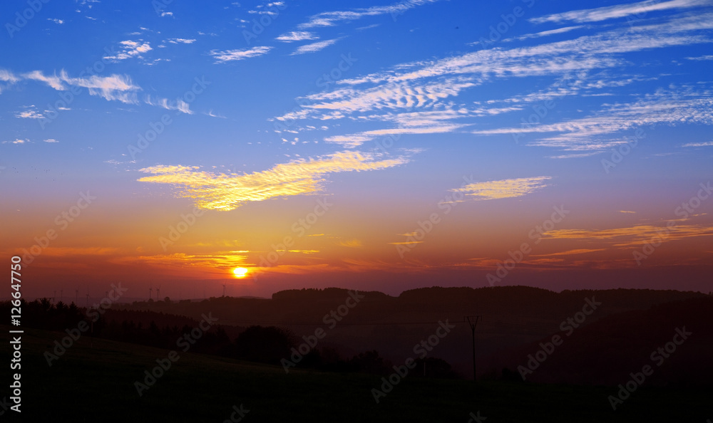 Colorful sky with sun background in mountains.