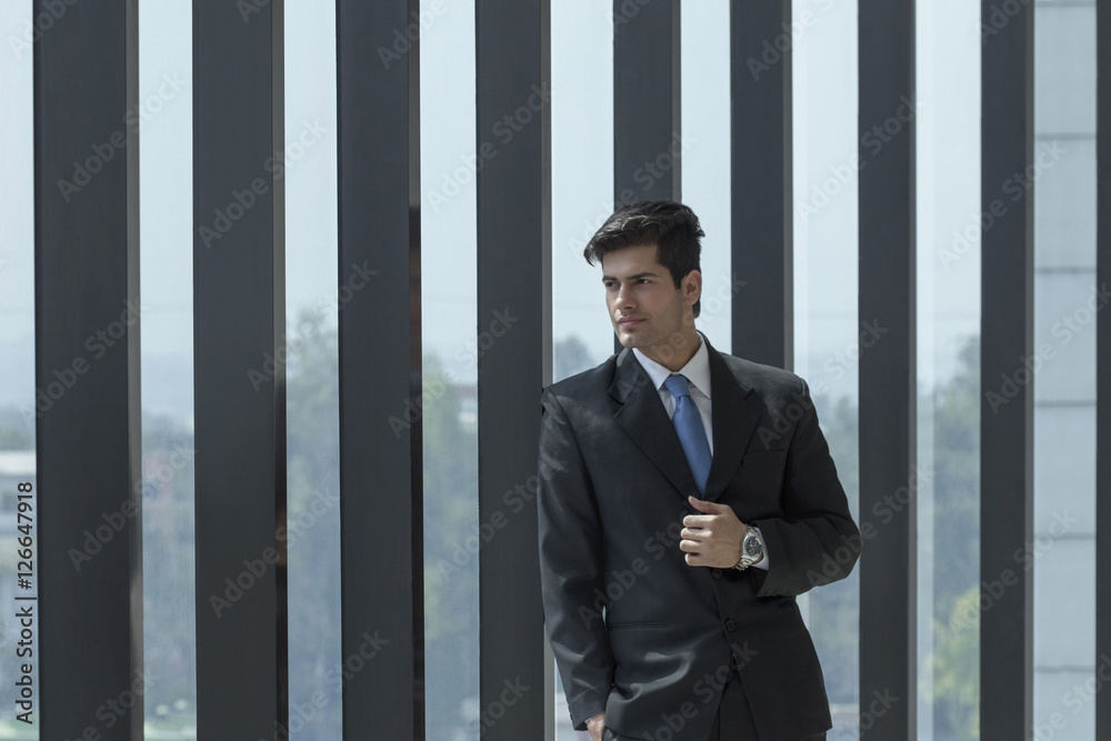 India, Man in suit standing outside building India, Man in suit standing outside building