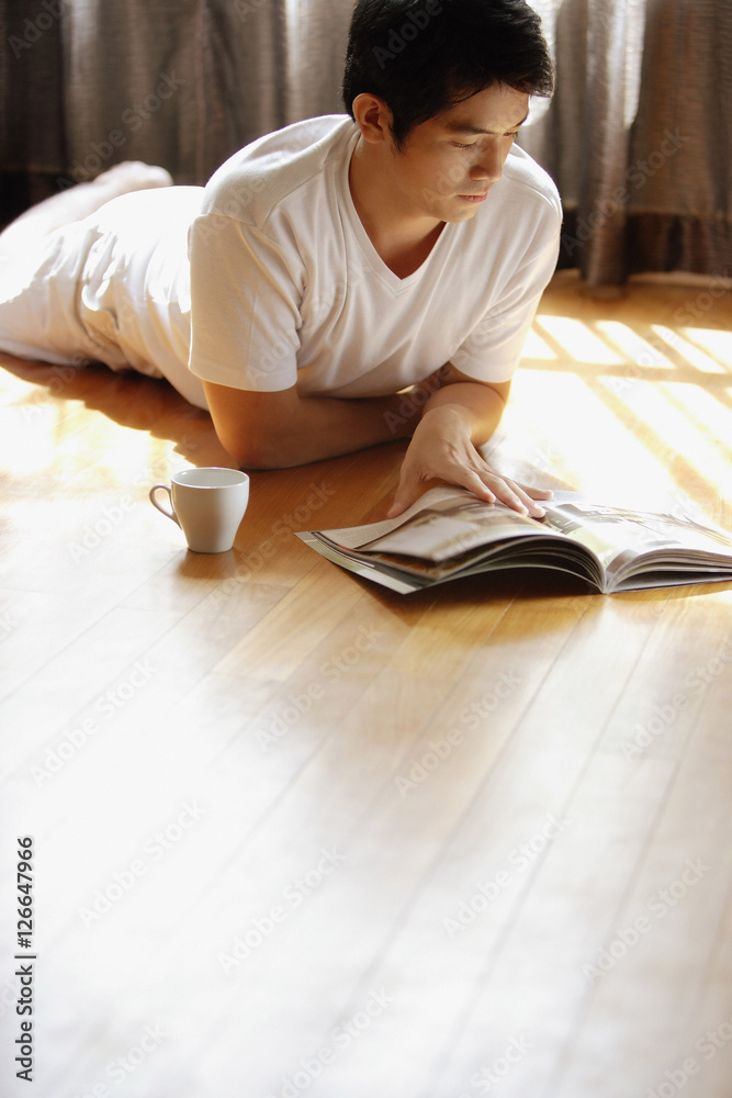 Young man reading magazine Young man reading magazine