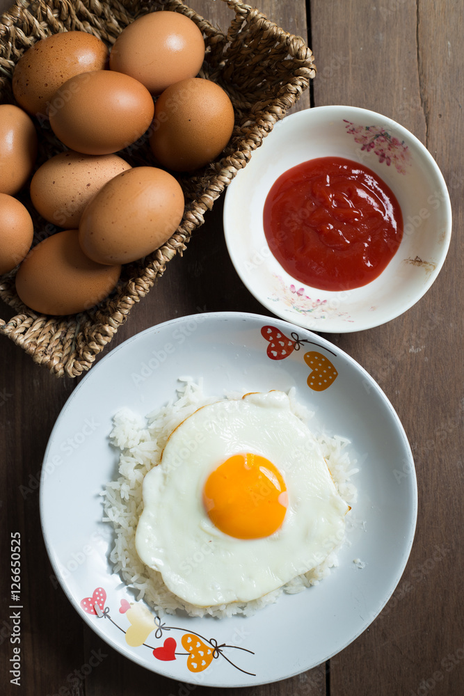 Fried egg on cooked rice and fresh eggs. Fried egg on cooked rice and fresh eggs.