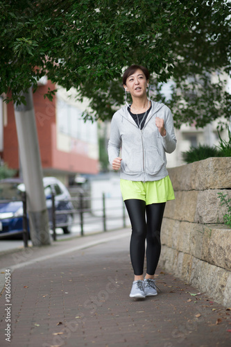 街中をジョギングするミドル女性 © hanack