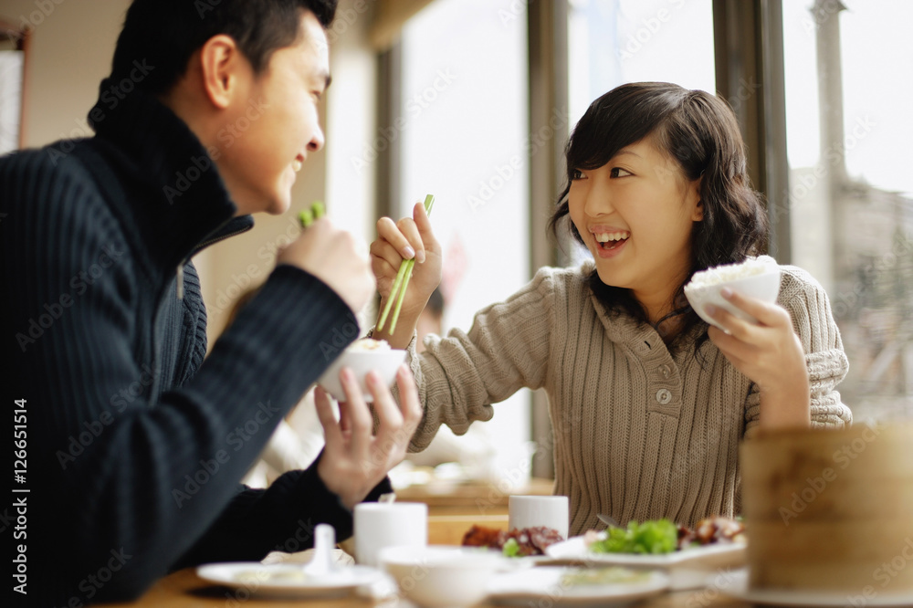 Young couple eating at a Chinese restaurant