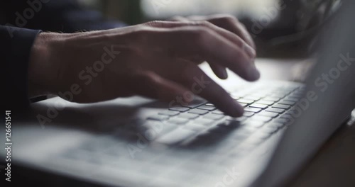 Man typing on computer keyboard photo