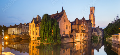 Panorama of Bruges, Belgium. Image with Rozenhoedkaai in Brugge, Dijver river canal and Belfort, Belfry, tower in twilight. photo