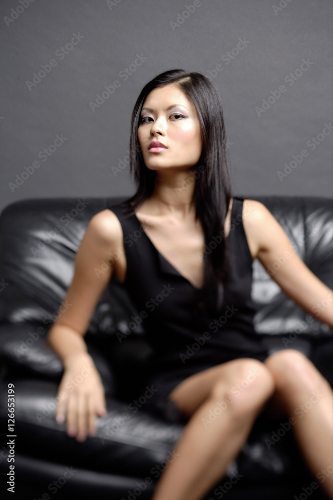 Young woman on chair, looking at camera Young woman on chair, looking at camera