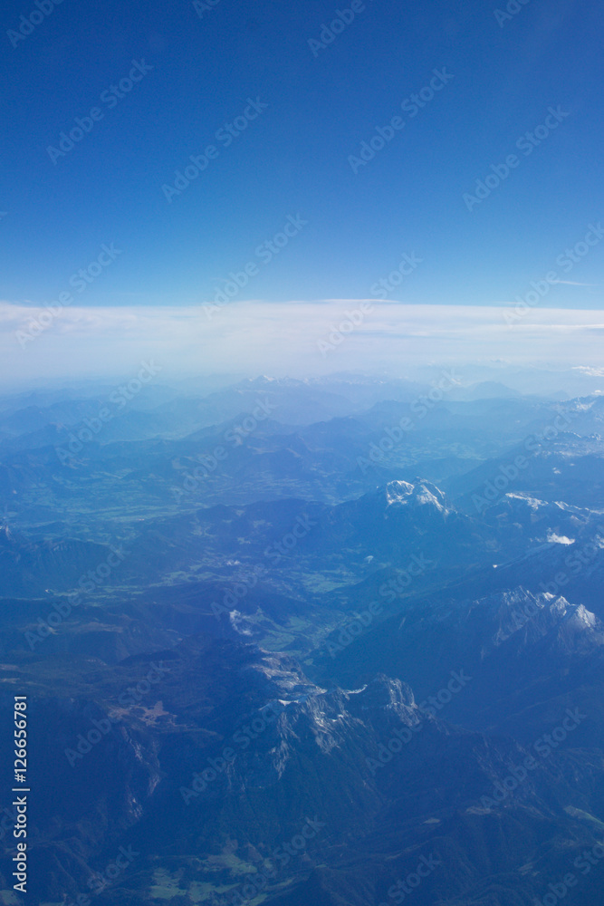AUSTRIA - October 2016: The alps as seen from an airplane, plane view of mountains.
