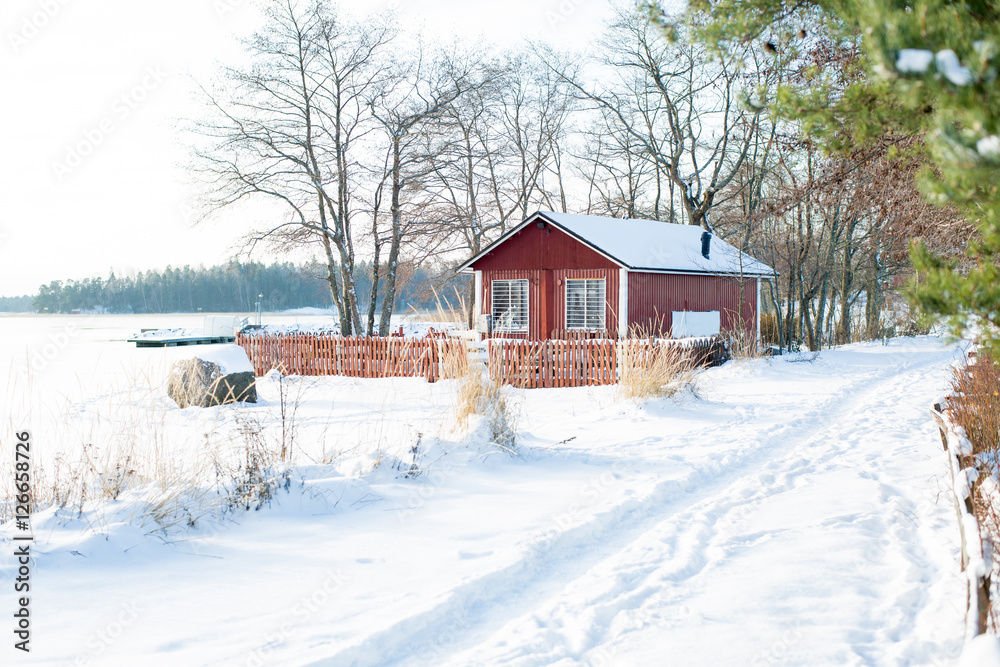 Finland. Baltic sea, bay. Empty beach covered with snow. High blu sky, frost, footprint. Abandoned cafe house. Scenic peaceful winter landscape. 