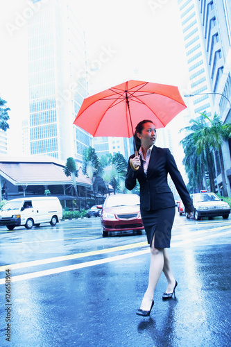 Photography Business woman with umbrella, crossing the road