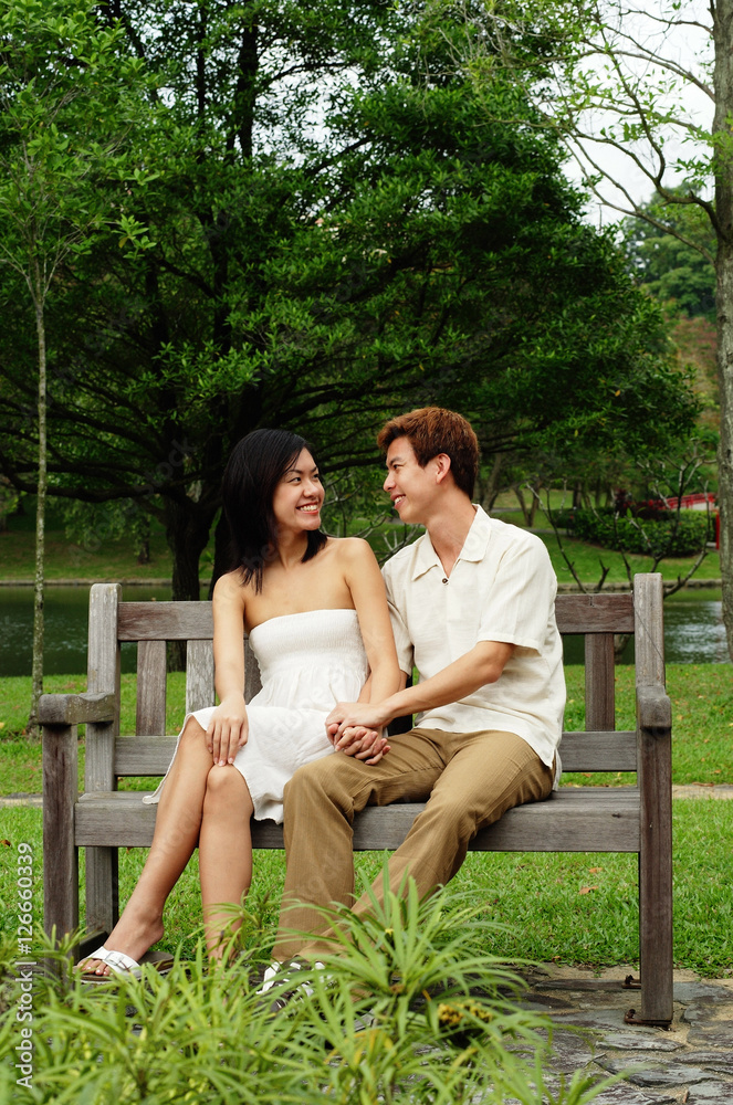 Couple sitting on park bench Couple sitting on park bench