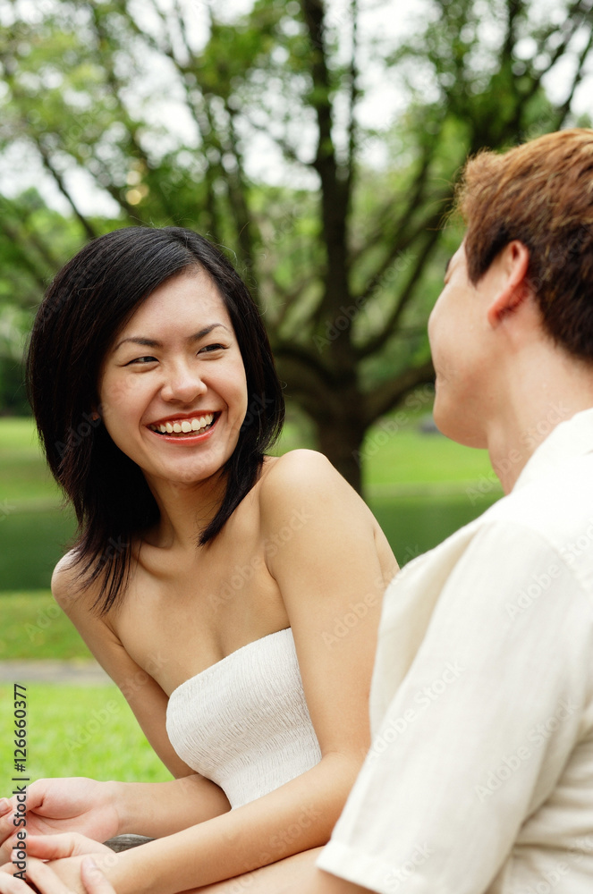 Woman smiling at man sitting next to her Woman smiling at man sitting next to her