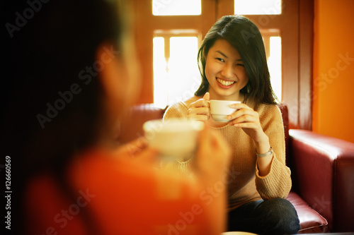 Two young women drinking tea