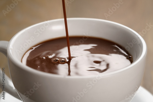 hot chocolate pouring in cup