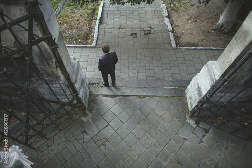 Wallpaper Mural Elegant groom is posing on street alone Torontodigital.ca