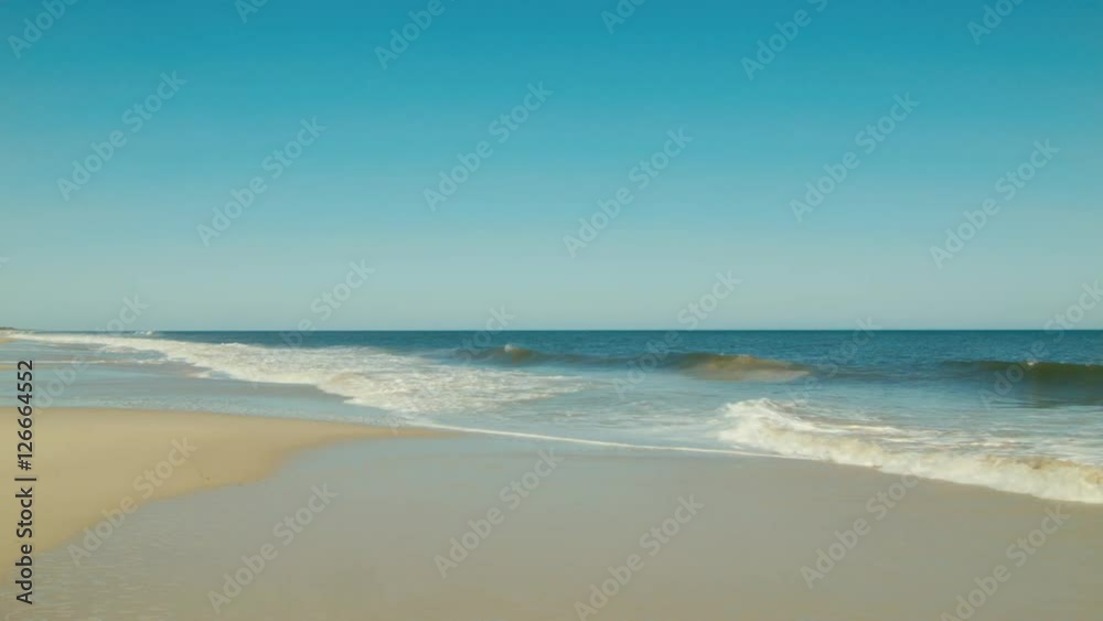 Waves Washing Ashore On A Sandy Beach Waves Washing Ashore On A Sandy Beach