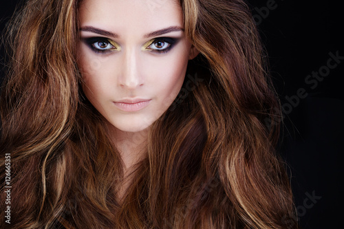 Glamorous Woman with Long Permed Hair and Smokey Eyes Makeup