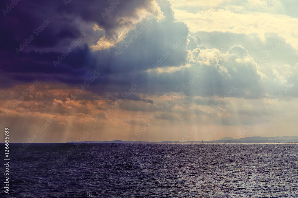 Sea landscape with bad weather and the cloudy sky. Dramatic cloudy sunset with sunbeams. Sea landscape with bad weather and the cloudy sky. Dramatic cloudy sunset with sunbeams.