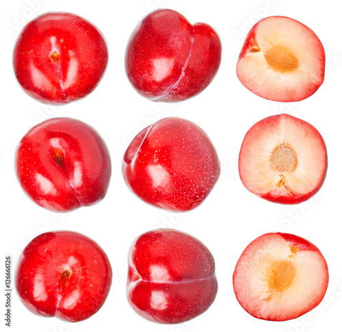 Red ripe plums isolated on white background. Useful vitamins.