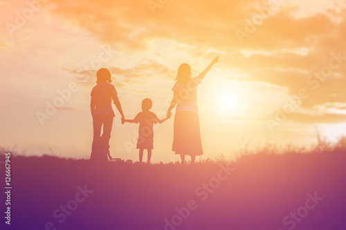 Happy family dancing on the road in the sunset time. Evening par © chaunpis