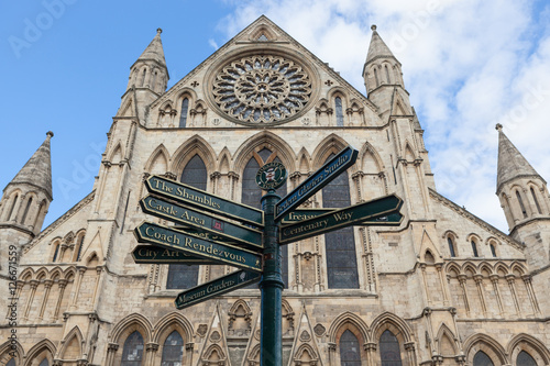 A view looking up at York Minster with a sign post, York, England.