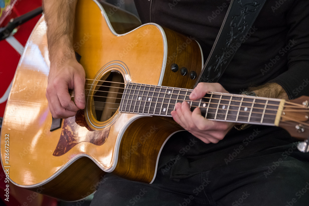 Fototapeta premium Man plays the acoustic guitar