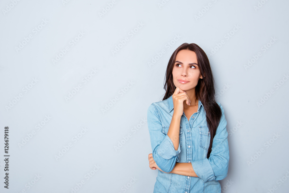 Beautiful minded woman dreaming about future on gray background Beautiful minded woman dreaming about future on gray background