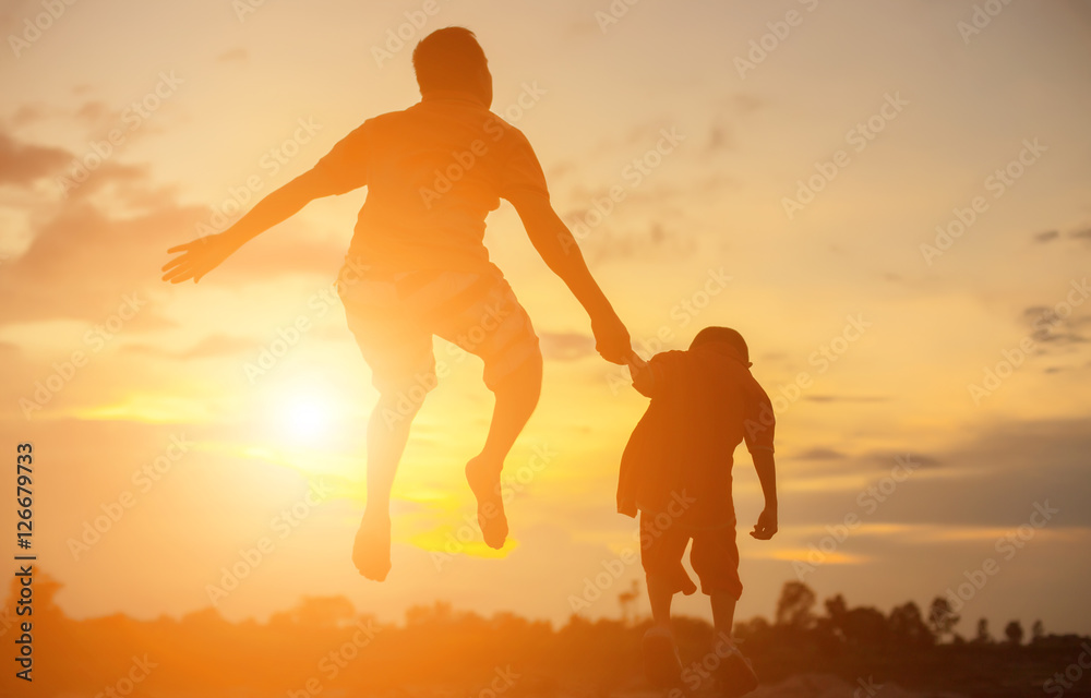 Happy dad throws the baby at sunset