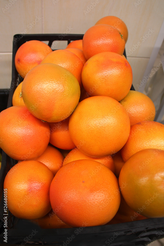 Lots of bright fresh oranges in supermarket, closeup