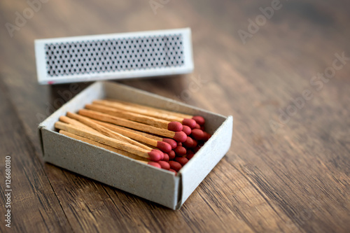 Box of matches on wood table baclground.
