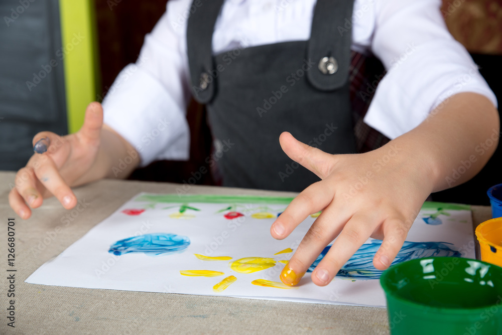 Child paiting the paint with your fingers Child paiting the paint with your fingers