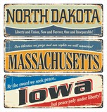 Vintage tin sign collection with USA state. North Dakota. Massachusetts. Iowa. Retro souvenirs or old postcard templates on rust background.