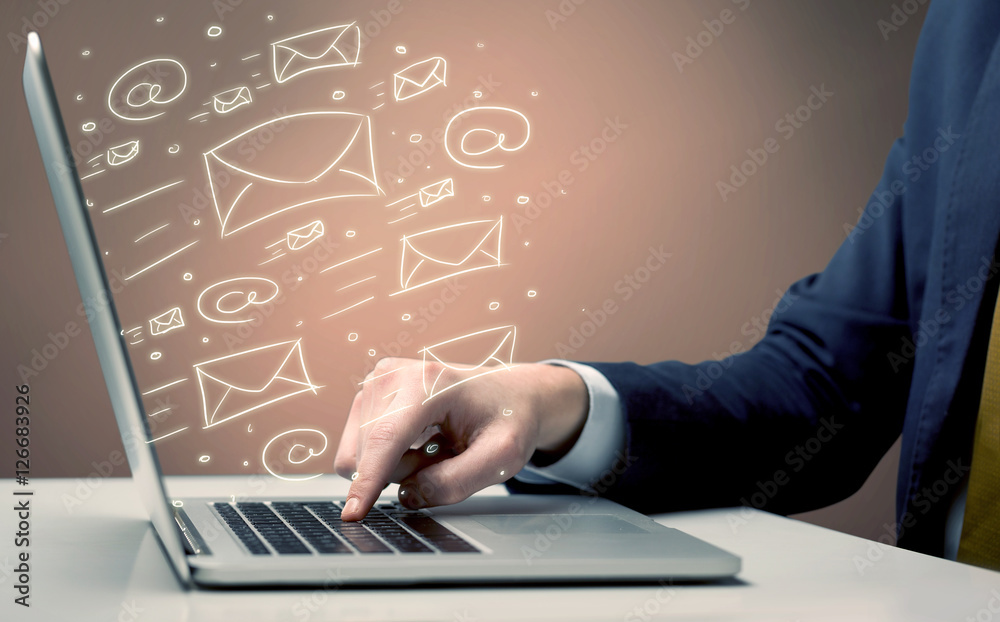 Sending client news letters on laptop Sending client news letters on laptop