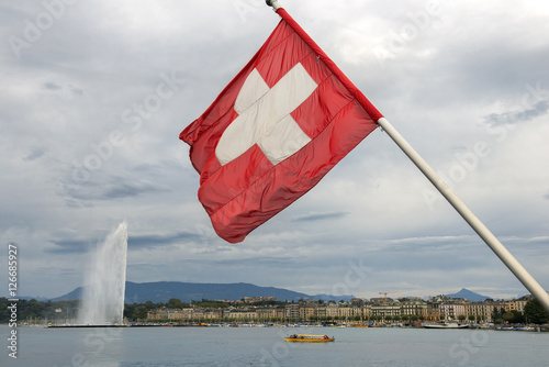 swiss flag on the background of lake Geneva
