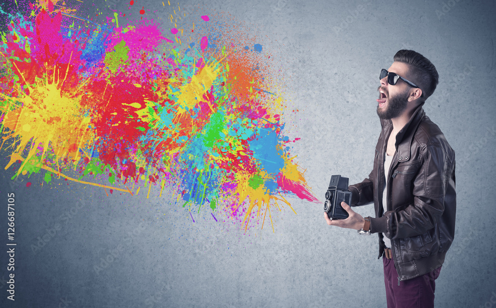 Hipster guy with camera and paint splash Hipster guy with camera and paint splash