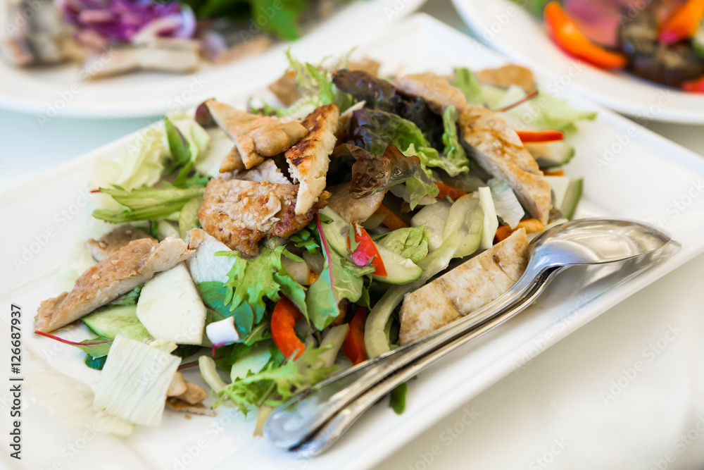 Vegetable salad on serving table. Sliced vegetables on a platter and spoon for eating. Herbal dietary a rural food. Food for Breakfast, lunch and dinner for weight loss and vegetarians. Vegetable salad on serving table. Sliced vegetables on a platter and spoon for eating. Herbal dietary a rural food. Food for Breakfast, lunch and dinner for weight loss and vegetarians.