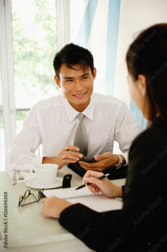 Business people having a discussion over coffee Business people having a discussion over coffee
