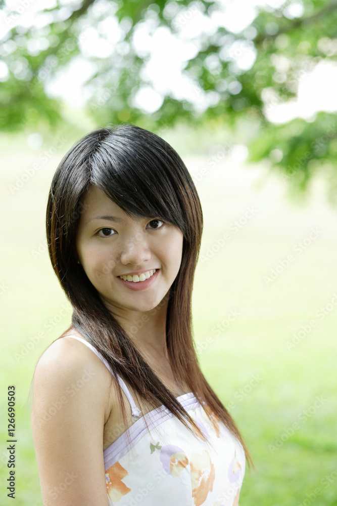 Young woman smiling at camera, head shot