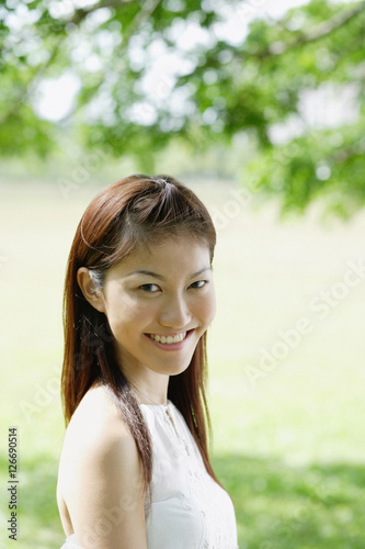 Young woman looking at camera, smiling