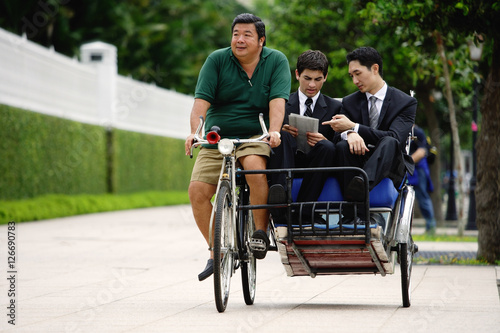Photography Businessmen riding in trishaw