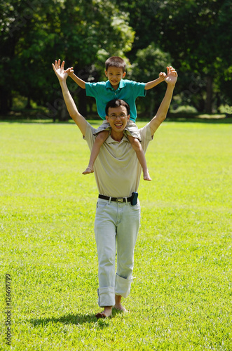 Father carrying son on shoulders