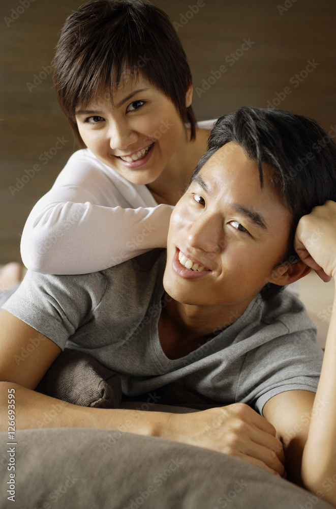 Couple looking at camera, woman leaning on man, portrait Couple looking at camera, woman leaning on man, portrait