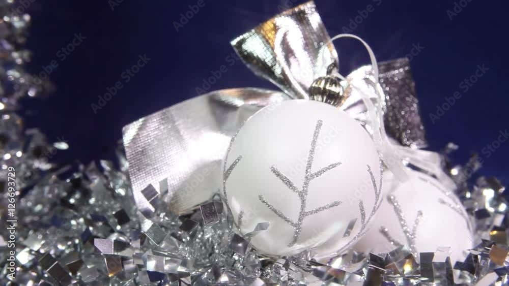New Year's balls and ribbon on a blue background
