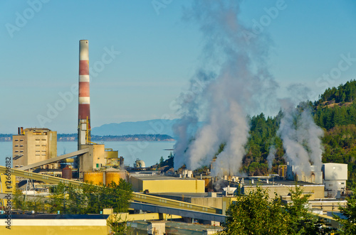 Power plants generating smokes at sunrise