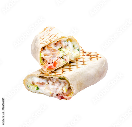 Tasty pita sandwich with lettuce, cheese, chicken fillet, fresh vegetables, mayonnaise, spices on a white background, isolated. Homemade wrap, street food concept.