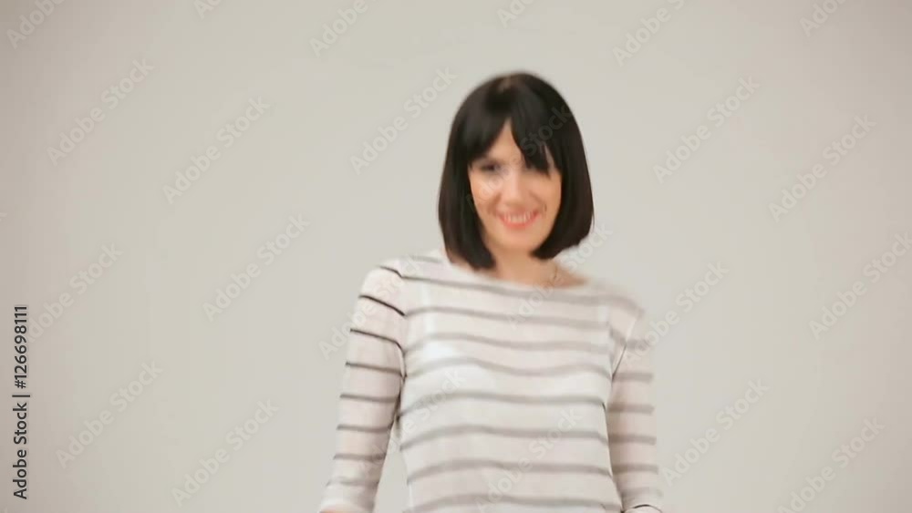 Young brunette smiling and dancing