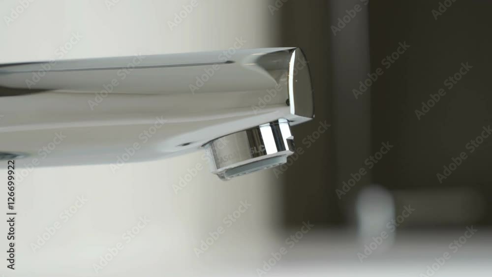 Drops of water seep through the water faucet Drops of water seep through the water faucet