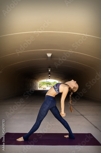 Beautiful woman stretching after a workout photo