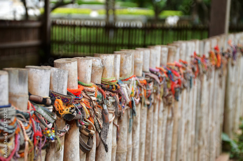 Billede på lærred Colored bracelets of the killing fields of Choeung Ek in Phnom P