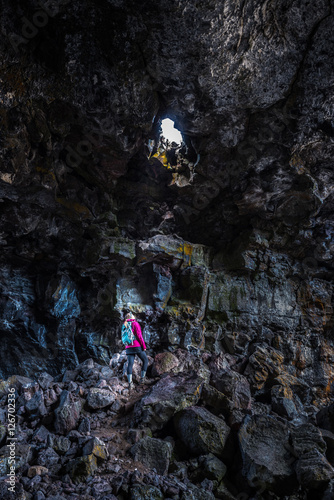 Hiker exploring Indian Tunnel Cave Craters of the Moon National Monument and Preserve Idaho photo