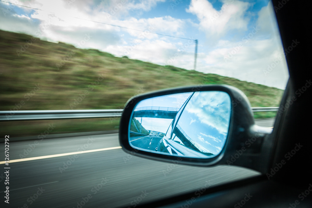 car on the road and rear view mirror